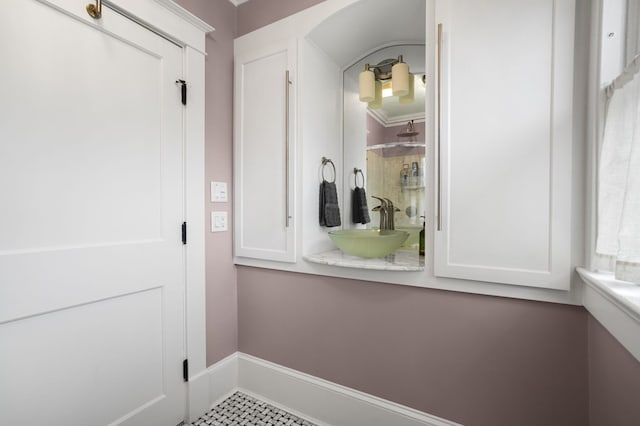 mudroom with baseboards and a sink