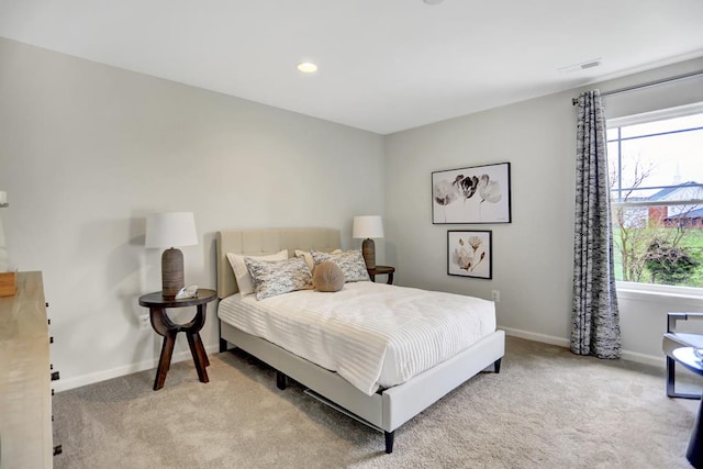 carpeted bedroom with multiple windows