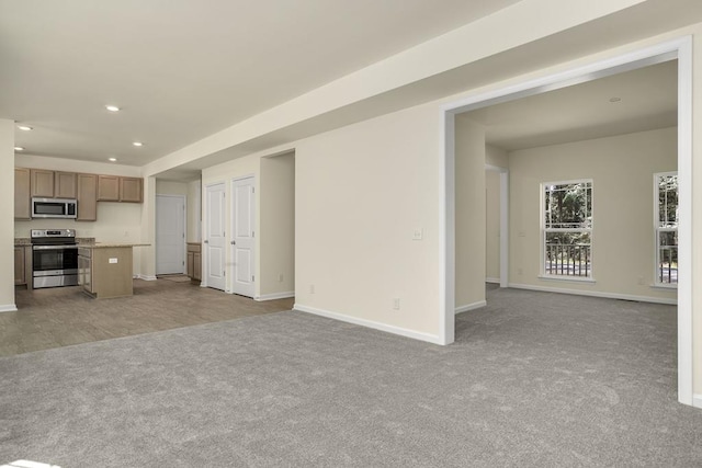 unfurnished living room featuring light colored carpet