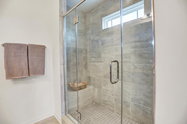 bathroom with a shower with shower door