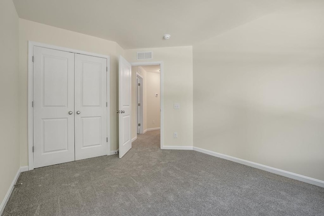 unfurnished bedroom featuring a closet and carpet floors