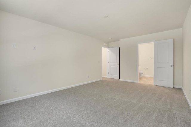 spare room featuring light colored carpet