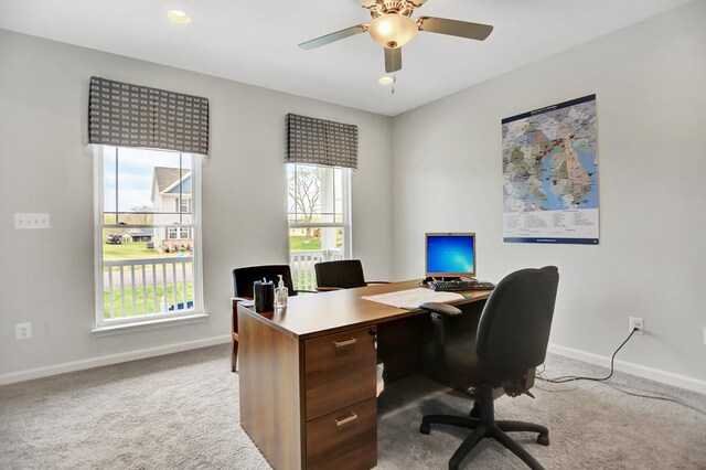 carpeted home office with ceiling fan