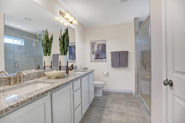 bathroom featuring tile patterned flooring, a shower with door, vanity, and toilet