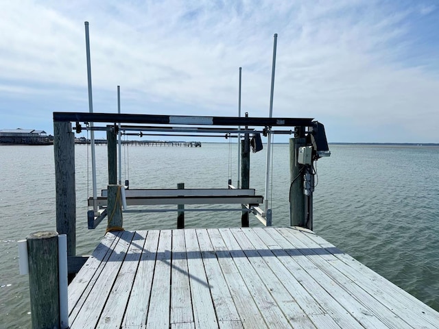 view of dock with a water view and boat lift