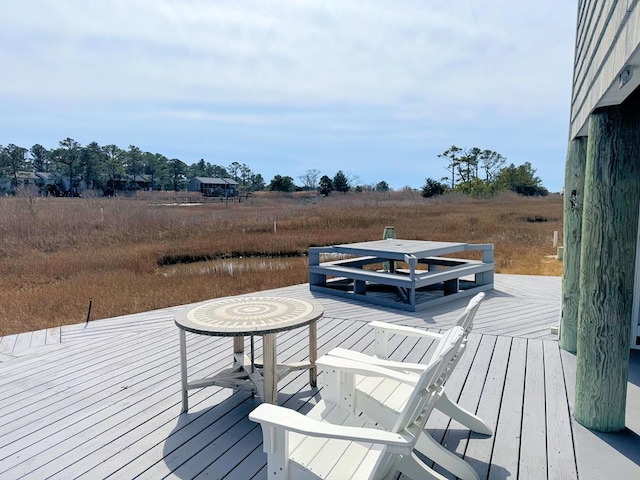 wooden terrace featuring a rural view