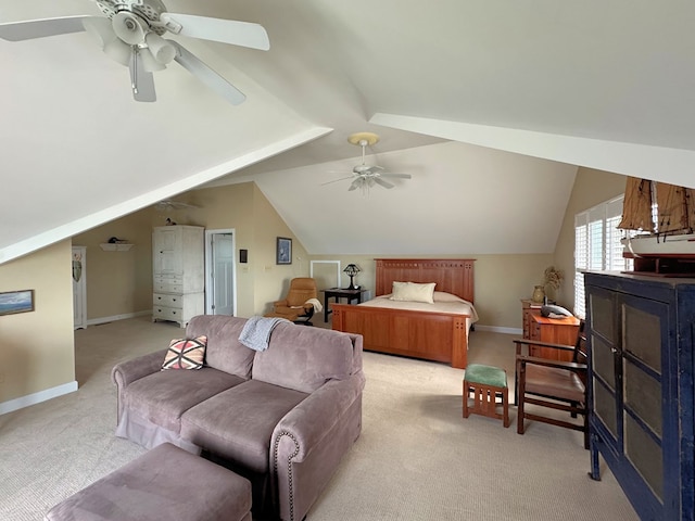 bedroom with light colored carpet, lofted ceiling, baseboards, and ceiling fan