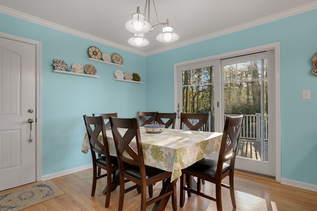 10388 Highland Ct, Exmore, VA 23350 - dining space featuring crown molding, light wood finished floors, a chandelier, and baseboards