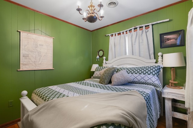 bedroom featuring dark wood-type flooring, a chandelier, and ornamental molding