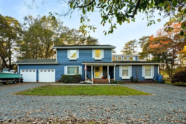 front facade featuring a front yard and a garage