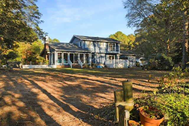 10388 Highland Ct, Exmore, VA 23350 - back of property featuring a sunroom, a chimney, and a shingled roof