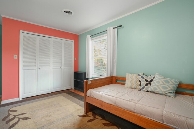 bedroom with a closet and ornamental molding