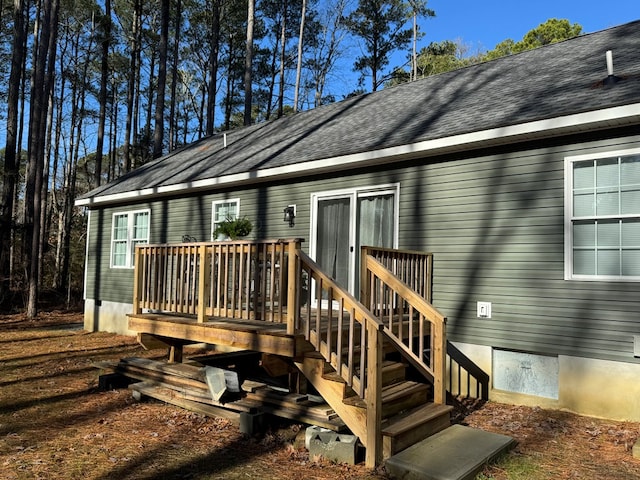 back of house with a wooden deck