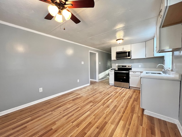 kitchen with white cabinetry, sink, light hardwood / wood-style flooring, and stainless steel appliances