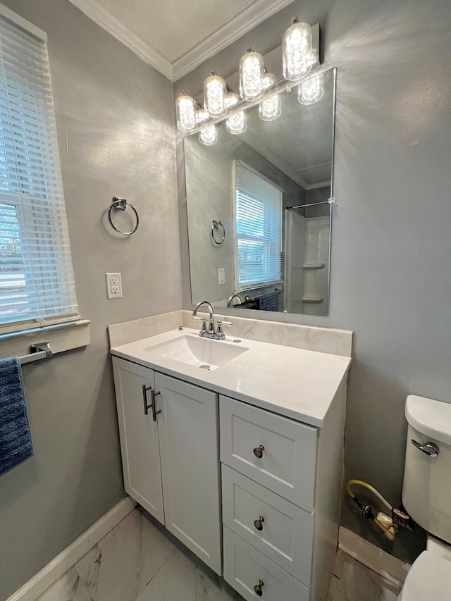 bathroom with vanity, ornamental molding, toilet, and walk in shower