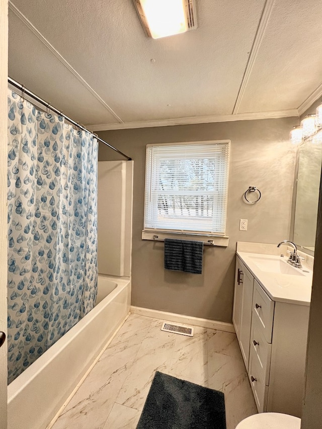 bathroom with crown molding, shower / bath combo with shower curtain, vanity, and a textured ceiling