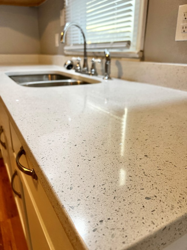 details featuring sink and light stone countertops