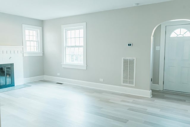 unfurnished living room with light hardwood / wood-style flooring