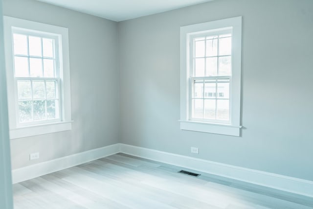 unfurnished room with light hardwood / wood-style flooring