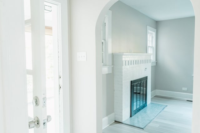 interior space with a fireplace and light hardwood / wood-style flooring