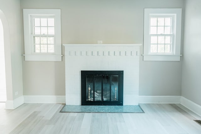 interior details featuring a fireplace and wood-type flooring