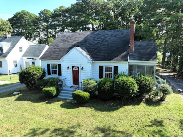 cape cod house featuring a front lawn