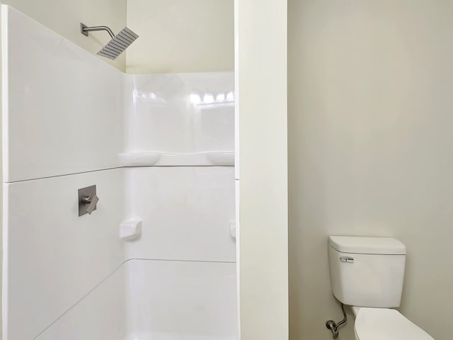 bathroom with walk in shower and toilet