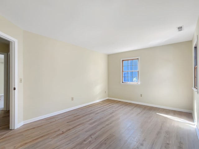 spare room with light hardwood / wood-style flooring