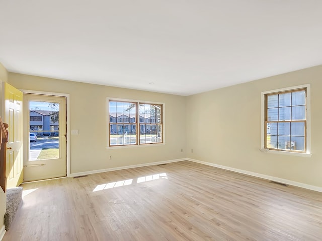 unfurnished room with light hardwood / wood-style flooring