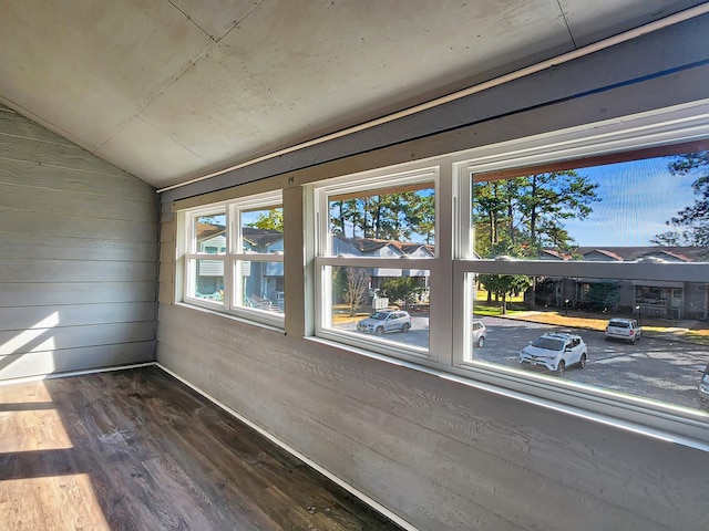 unfurnished sunroom featuring lofted ceiling