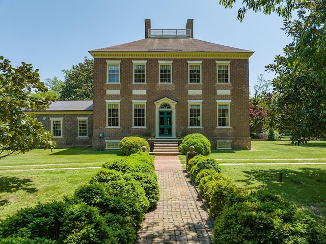 colonial home featuring french doors and a front yard