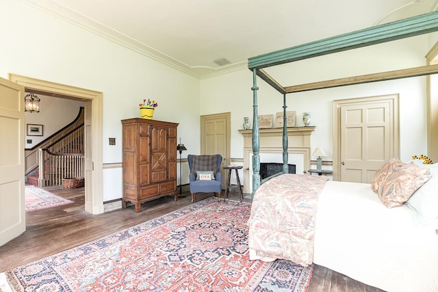 bedroom featuring dark wood-type flooring and ornamental molding