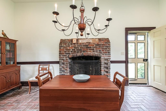 dining area featuring a notable chandelier and a fireplace