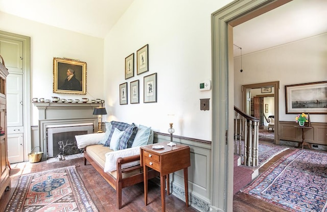 sitting room with hardwood / wood-style flooring and vaulted ceiling