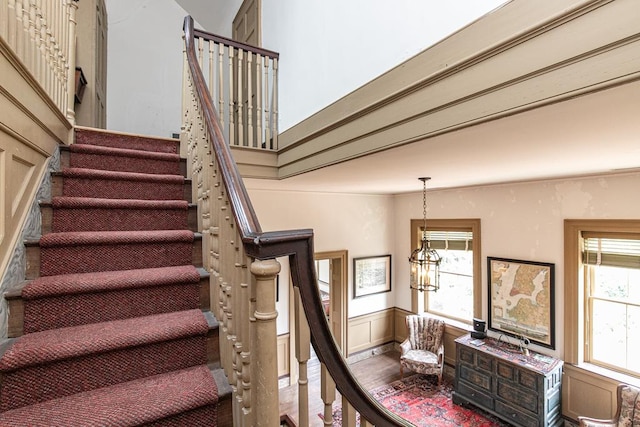 stairs with a high ceiling and an inviting chandelier