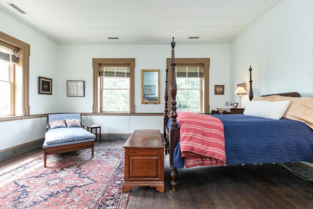 bedroom featuring hardwood / wood-style floors and crown molding