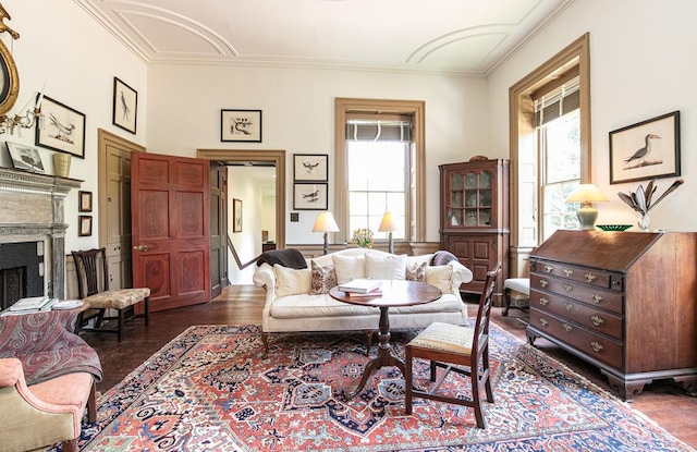 sitting room with a wealth of natural light, dark hardwood / wood-style floors, and ornamental molding