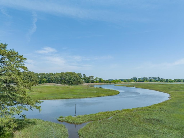 surrounding community featuring a yard and a water view