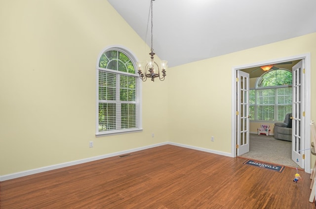 37323 Davey Jones Blvd, Greenbackville, VA 23356 - empty room with wood finished floors, a chandelier, baseboards, high vaulted ceiling, and french doors