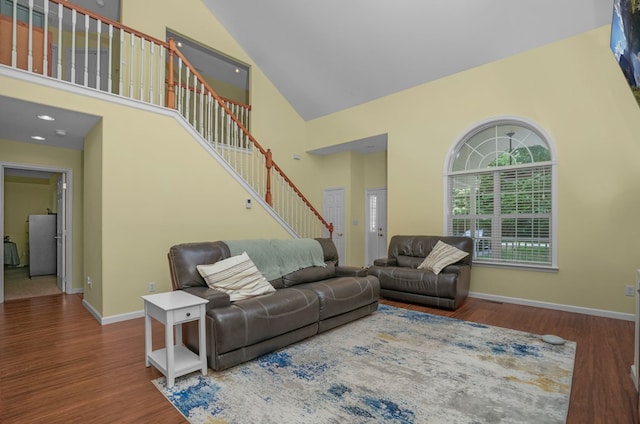 37323 Davey Jones Blvd, Greenbackville, VA 23356 - living room with high vaulted ceiling, stairs, wood finished floors, and baseboards
