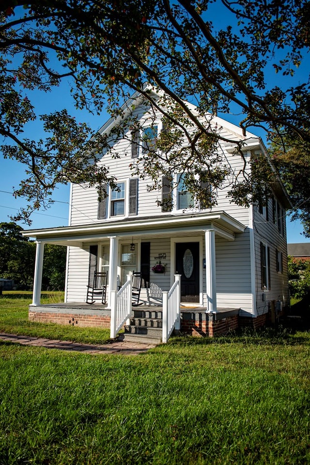 view of front of house featuring a front yard and covered porch