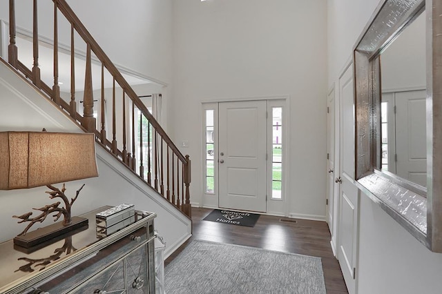 foyer featuring a high ceiling and dark hardwood / wood-style floors