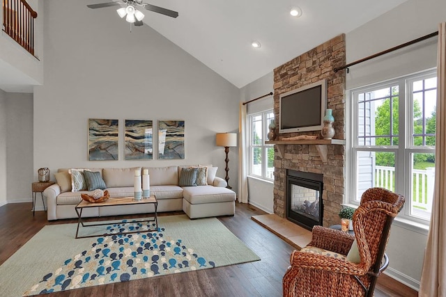 living room featuring a fireplace, dark hardwood / wood-style flooring, ceiling fan, and a healthy amount of sunlight