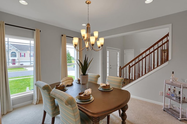 dining space with plenty of natural light, carpet floors, and a chandelier