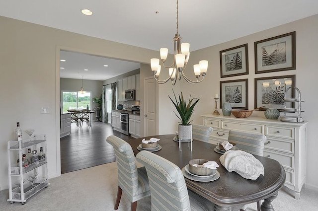 dining room with light colored carpet and a notable chandelier