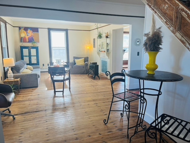 dining space featuring hardwood / wood-style floors and crown molding