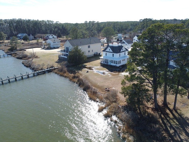 drone / aerial view featuring a forest view and a water view