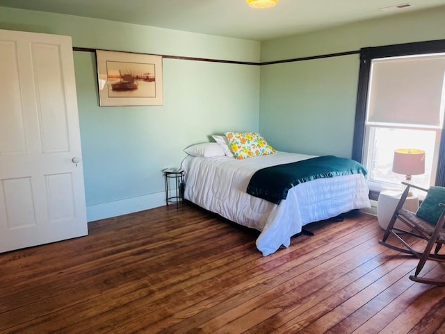 bedroom featuring baseboards and hardwood / wood-style floors