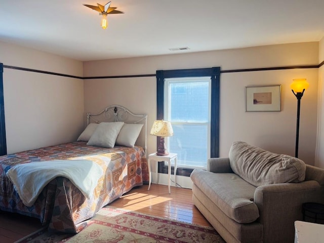 bedroom featuring hardwood / wood-style flooring and visible vents