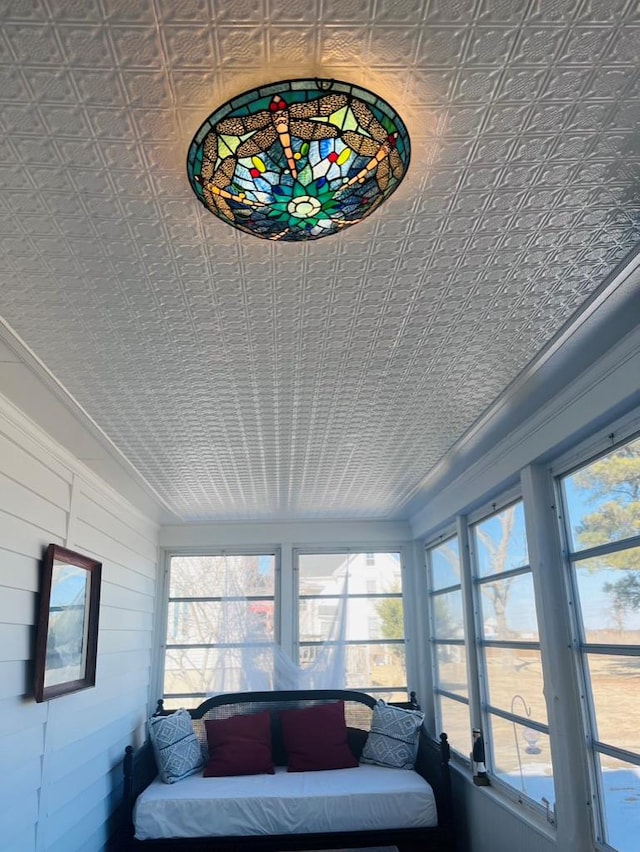 sunroom featuring an ornate ceiling